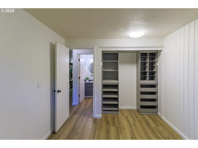 a view of wooden floor and windows in a room