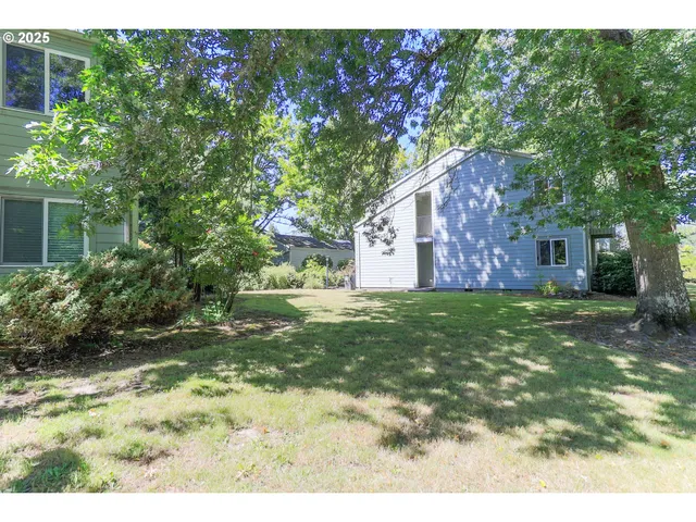 a backyard of a house with lots of green space