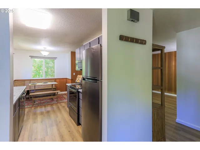 a kitchen with stainless steel appliances a refrigerator and a stove top oven