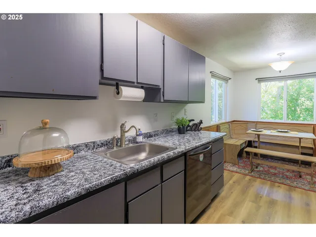 a kitchen with sink and cabinets