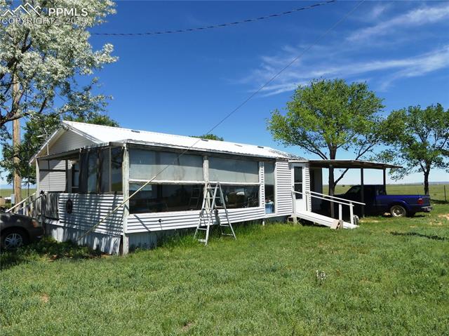 30150 Antioch Road Yoder, CO 80864 - Photo 5 of 36 Enclosed porch and Carport (east)