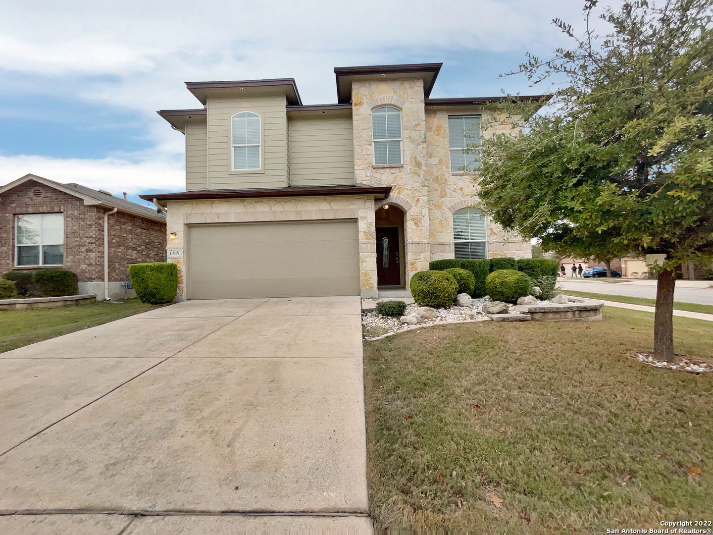 a front view of a house with a yard and garage