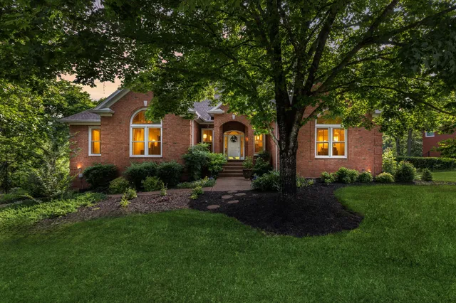 a front view of house with yard and green space