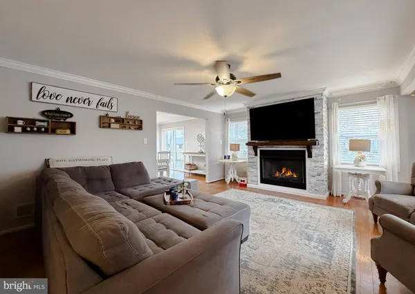 a living room with furniture fireplace and a large window