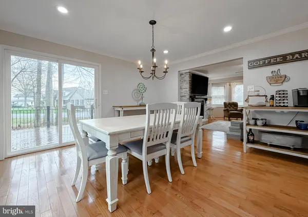 a view of a livingroom with a ceiling fan and wooden floor