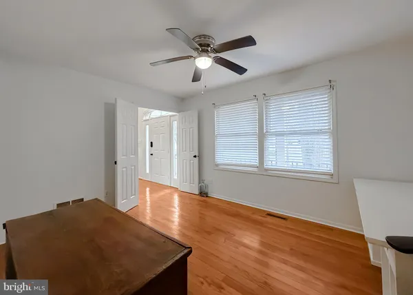 a spacious bedroom with a bed and a chandelier