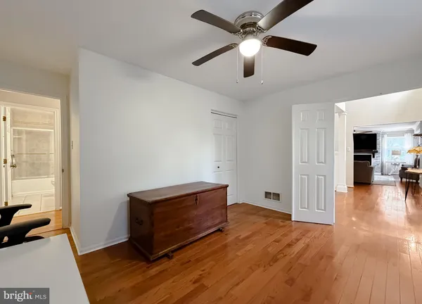 a white bed sitting in a bedroom next to a window