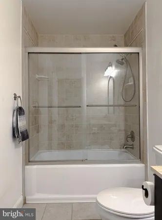 a bedroom with a large bed and a flat screen tv