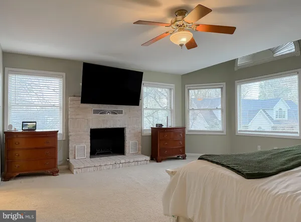 a bed room with a bed and a ceiling fan