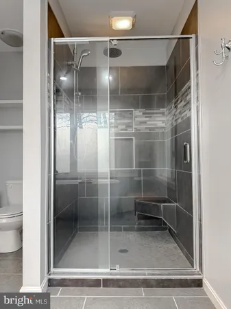 a bedroom with a large bed and a flat screen tv