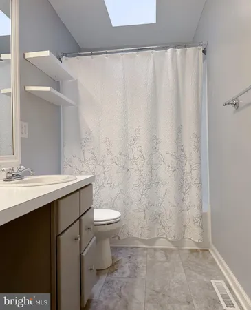 a view of a patio with table and chairs and couches with wooden floor and fence