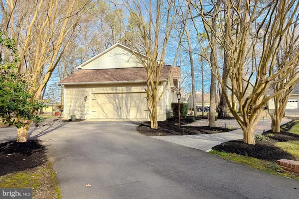 a view of a house with a yard and pathway