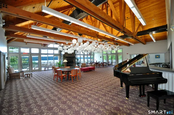 a dining room with furniture a chandelier and wooden floor