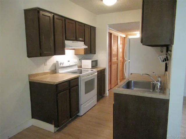 a kitchen with a sink cabinets and a window