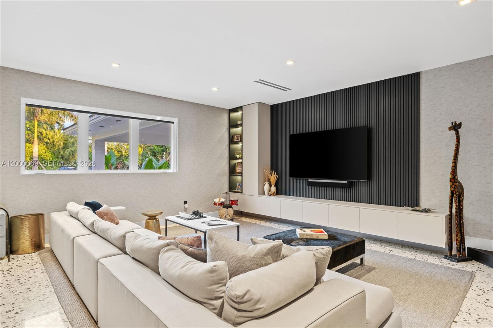 4800 Bay Point Road Miami, FL 33137 - Photo 11 of 74 a living room with couches and a flat screen tv