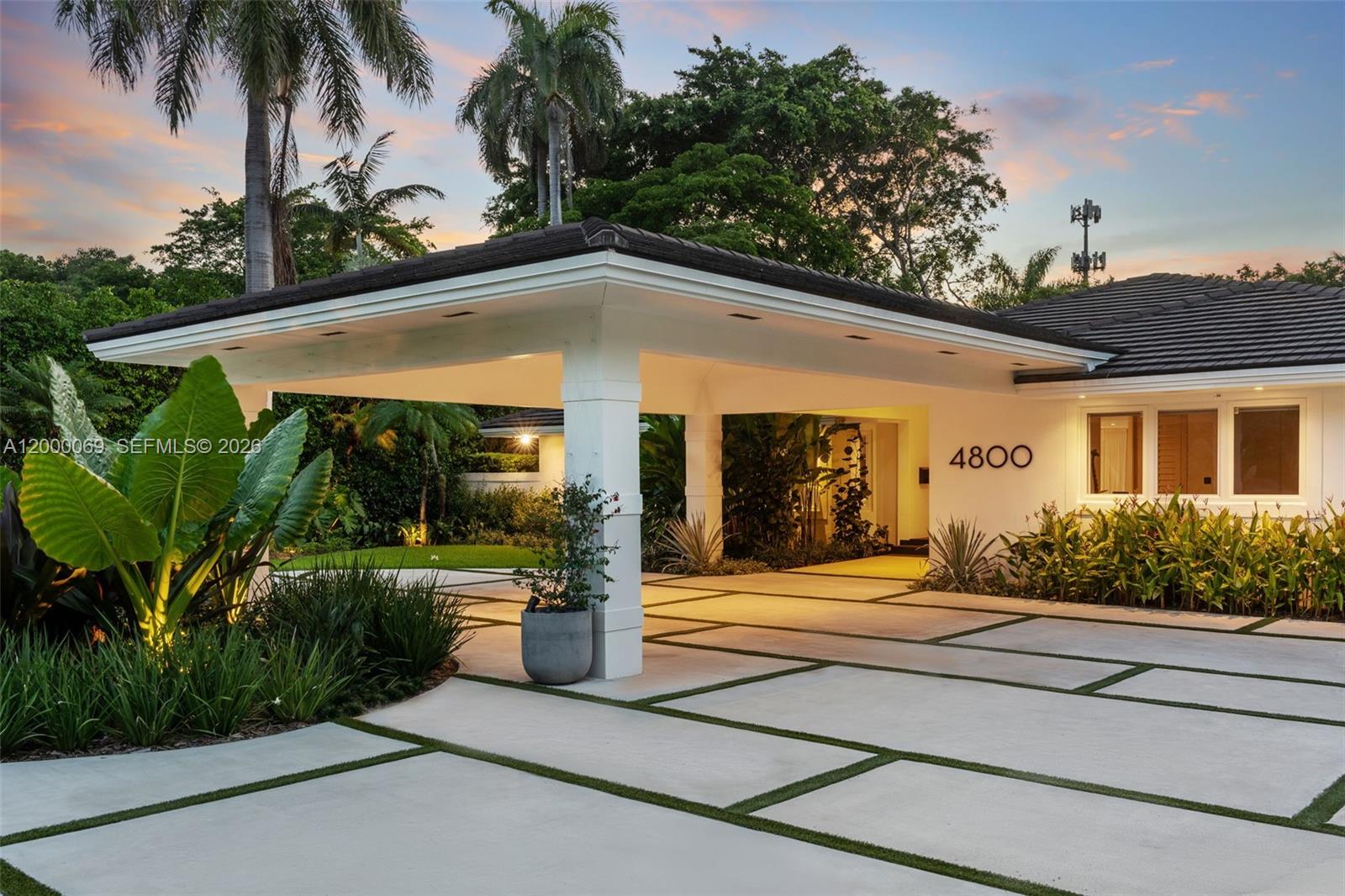 4800 Bay Point Road Miami, FL 33137 - Photo 17 of 74 a front view of a house with garden and porch