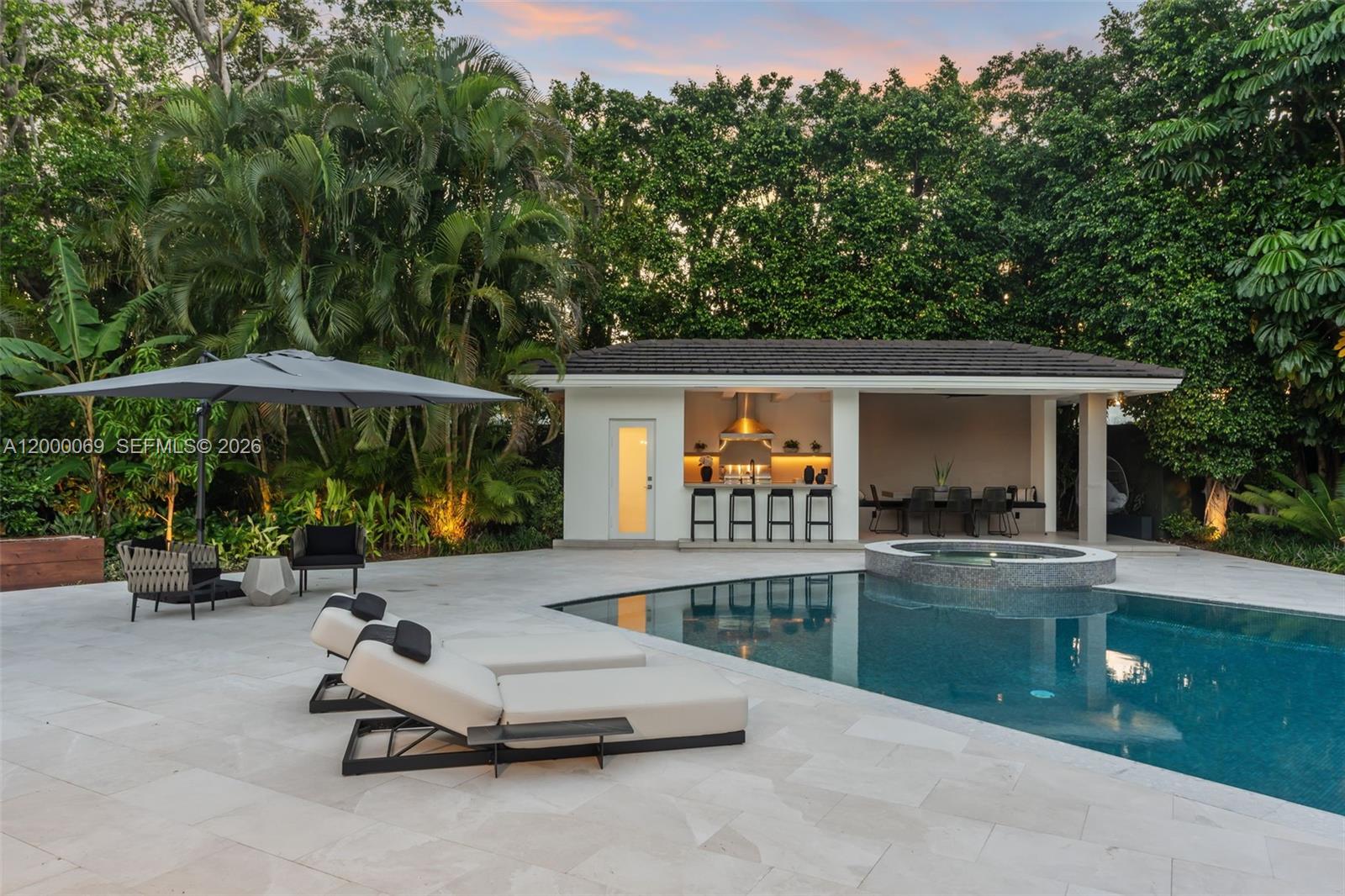 4800 Bay Point Road Miami, FL 33137 - Photo 57 of 74 a view of a patio with a table and chairs under an umbrella