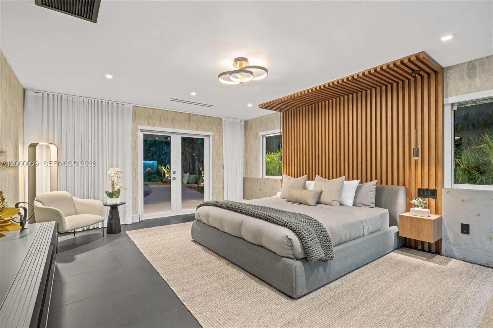 4800 Bay Point Road Miami, FL 33137 - Photo 69 of 74 a bedroom with a large bed couch and a window
