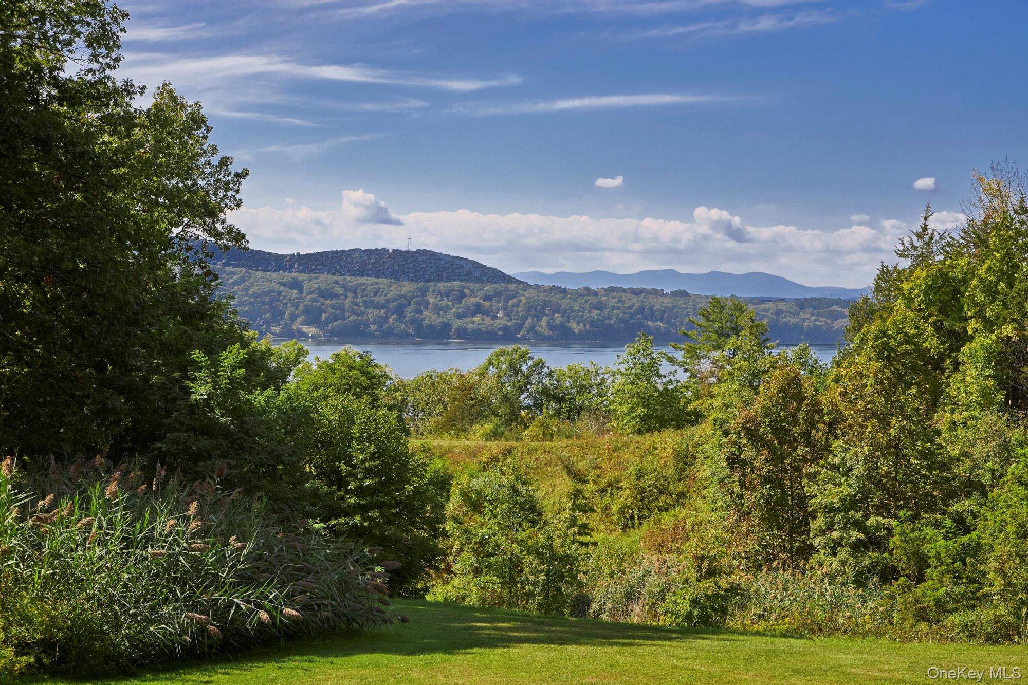 View of mountain backdrop featuring a heavily wooded area