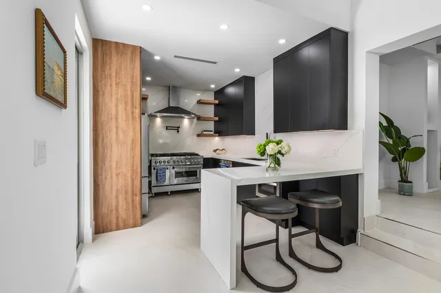 a kitchen with stainless steel appliances granite countertop sink cabinets and wooden floor