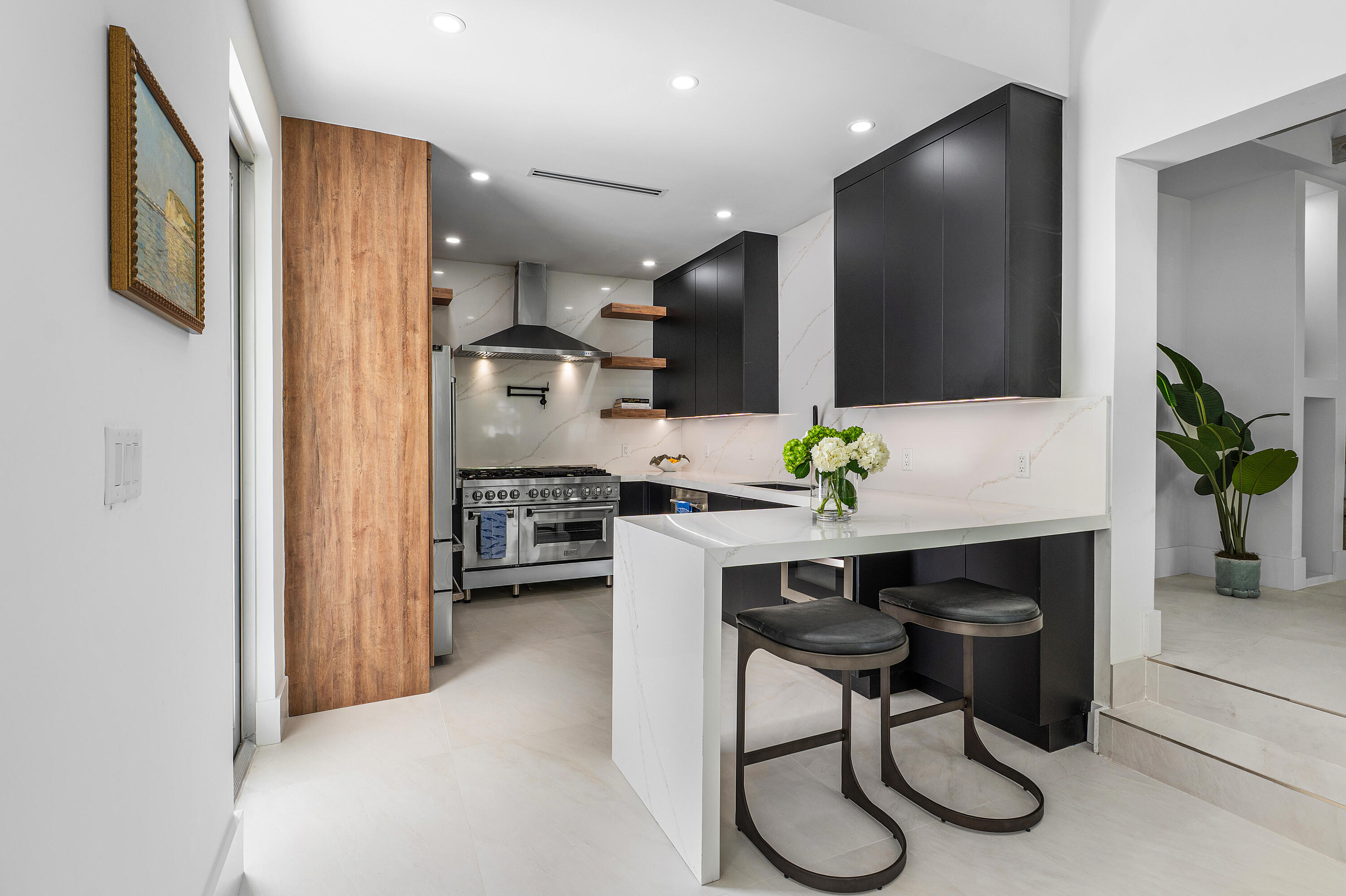 2330 Lake Avenue, Unit 2330 West Palm Beach, FL 33401 - Photo 11 of 44 a kitchen with stainless steel appliances granite countertop sink cabinets and wooden floor