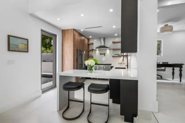 a kitchen with stainless steel appliances granite countertop a refrigerator and a sink