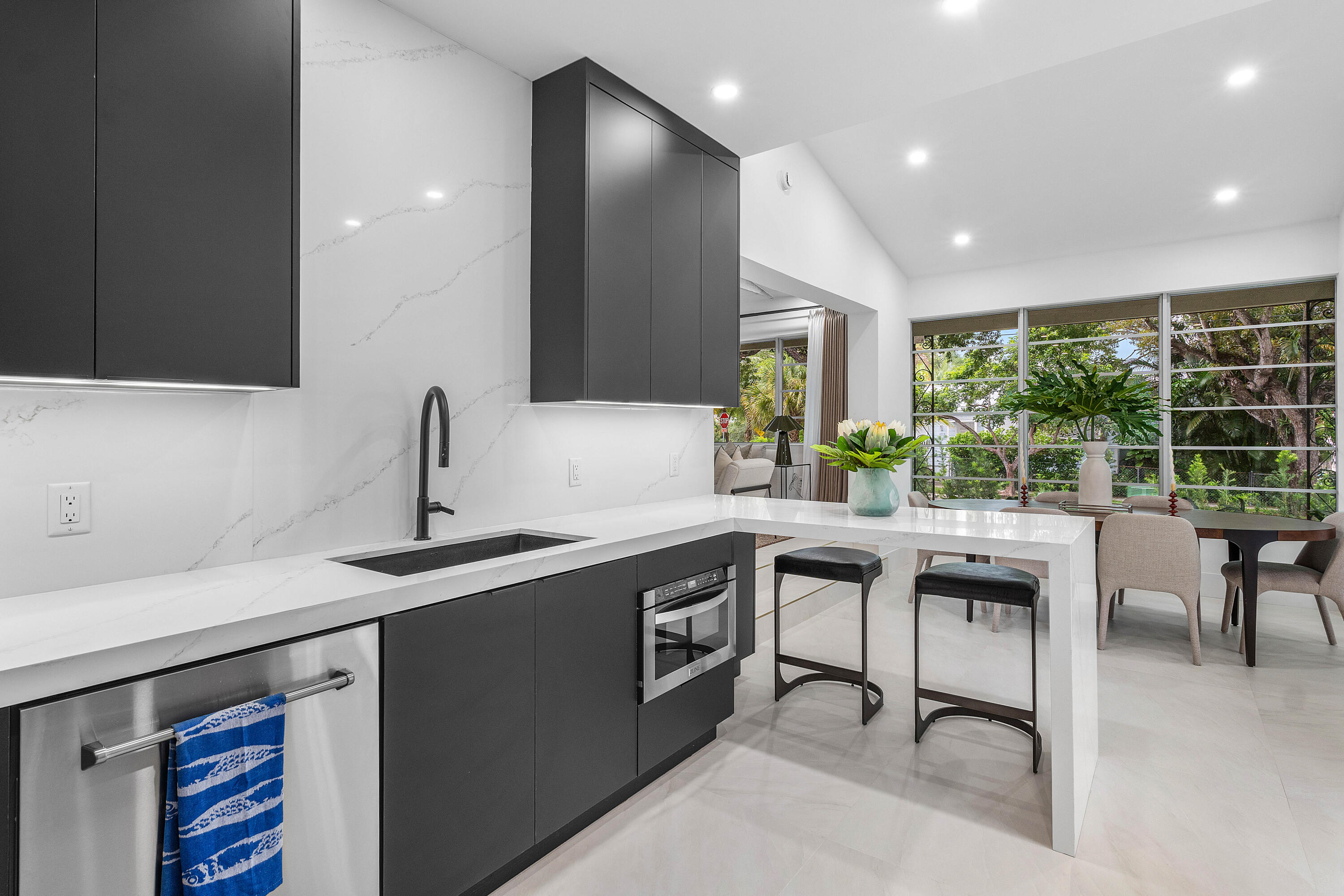 2330 Lake Avenue, Unit 2330 West Palm Beach, FL 33401 - Photo 14 of 44 a kitchen with stainless steel appliances granite countertop sink stove and island