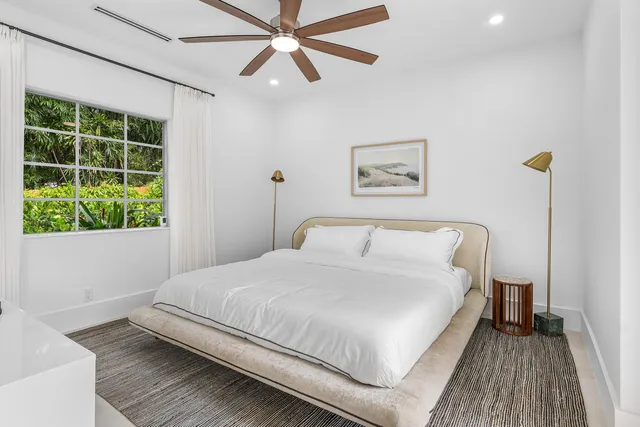 a bedroom with a large bed and a window