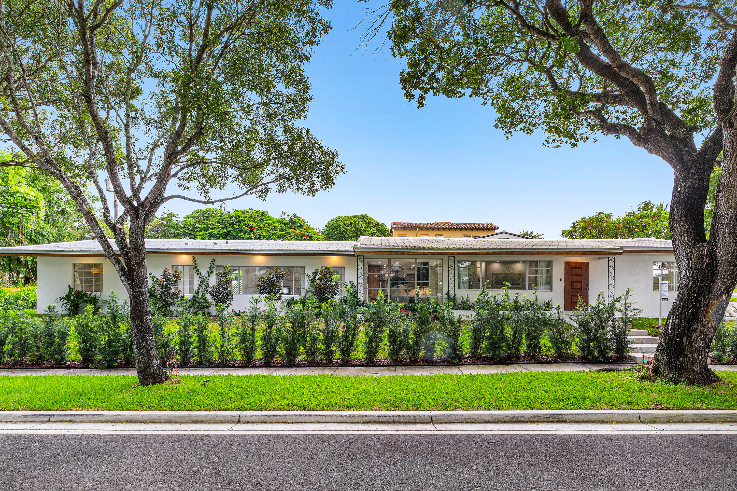 2330 Lake Avenue, Unit 2330 West Palm Beach, FL 33401 - Photo 2 of 44 a front view of a house with a garden and trees