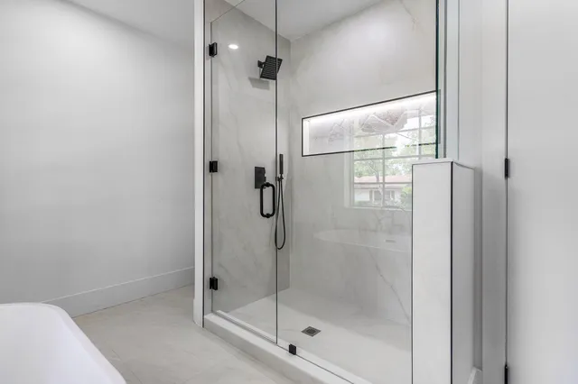 a bathroom with a glass shower door