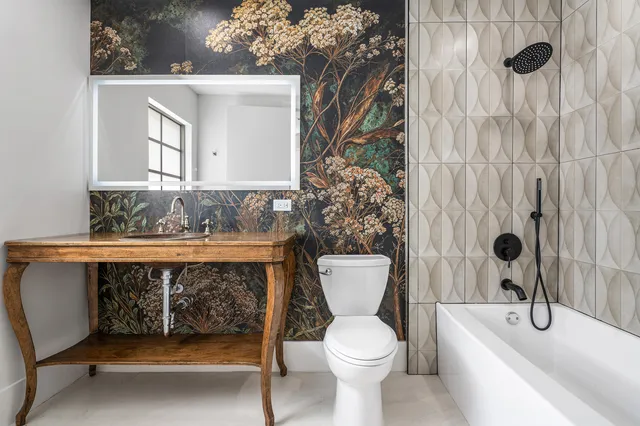 a bathroom with a toilet a sink and a mirror