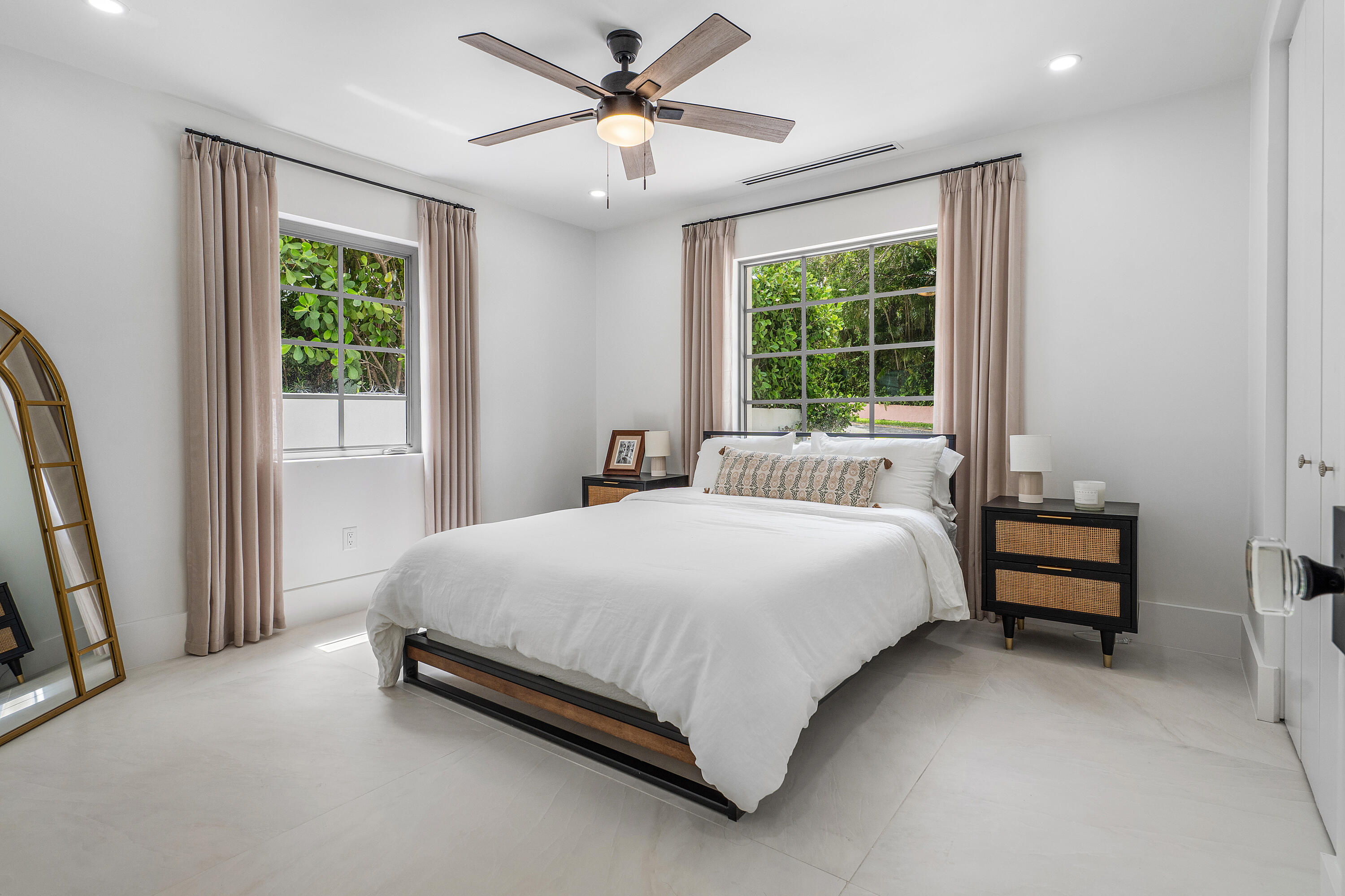 2330 Lake Avenue, Unit 2330 West Palm Beach, FL 33401 - Photo 29 of 44 a large bed sitting in a bedroom next to a window