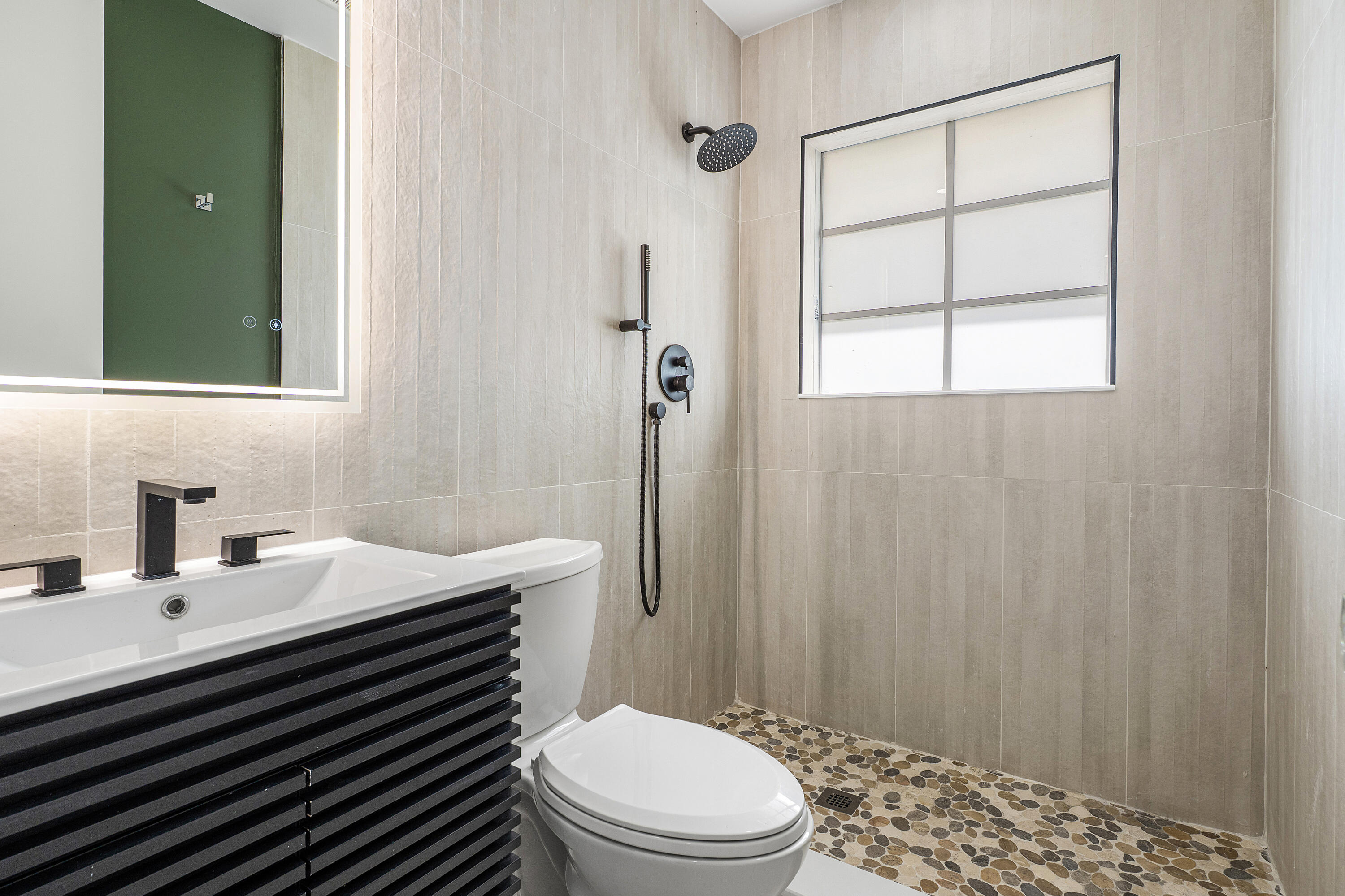 2330 Lake Avenue, Unit 2330 West Palm Beach, FL 33401 - Photo 30 of 44 a bathroom with a sink a toilet and shower