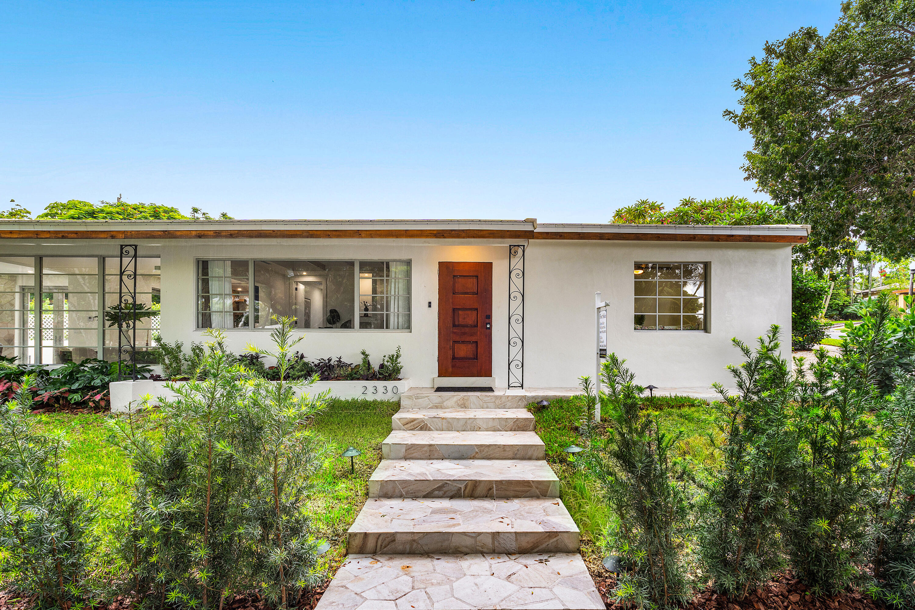 2330 Lake Avenue, Unit 2330 West Palm Beach, FL 33401 - Photo 3 of 44 front view of a house with a yard