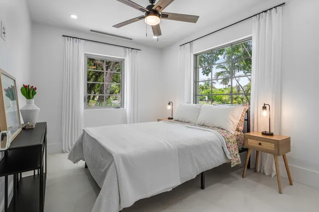 a bed room with a bed and a window