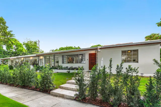a front view of house with yard and green space