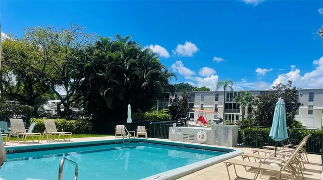 a view of swimming pool with chairs and tables