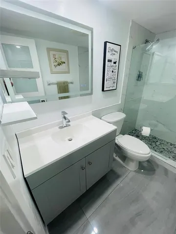 a bathroom with a sink toilet and mirror
