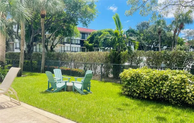 a view of a chair and table in the garden