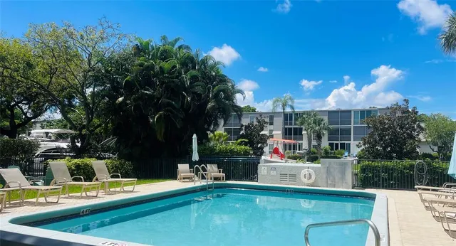 a view of a house with swimming pool and sitting area