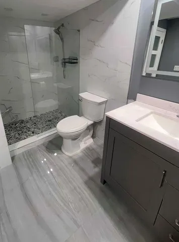 a bathroom with a toilet and a shower