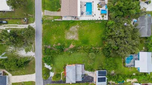 an aerial view of a house with a yard
