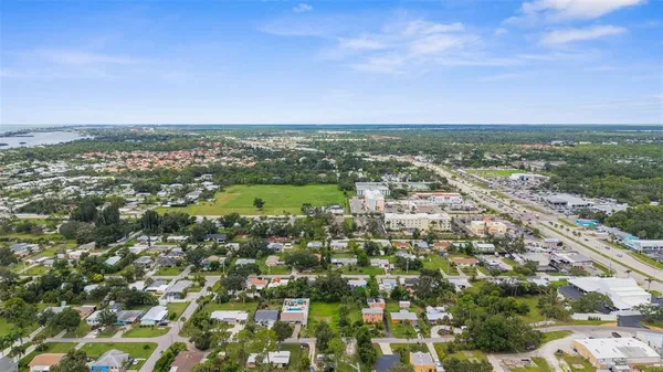 an aerial view of residential houses with city view