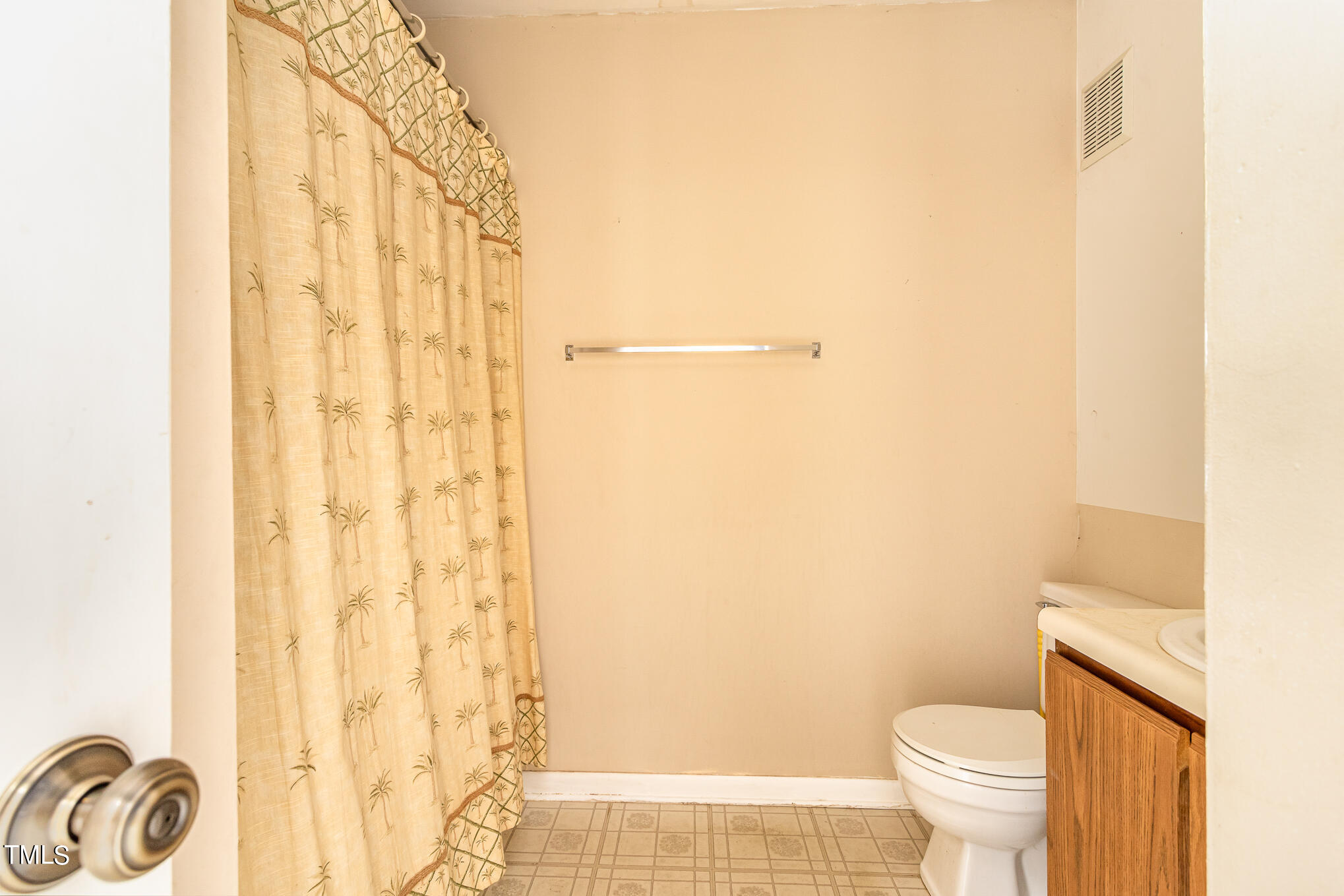 3051 Huntleigh Drive Raleigh, NC 27604 - Photo 10 of 16 a white toilet sitting next to a shower curtain