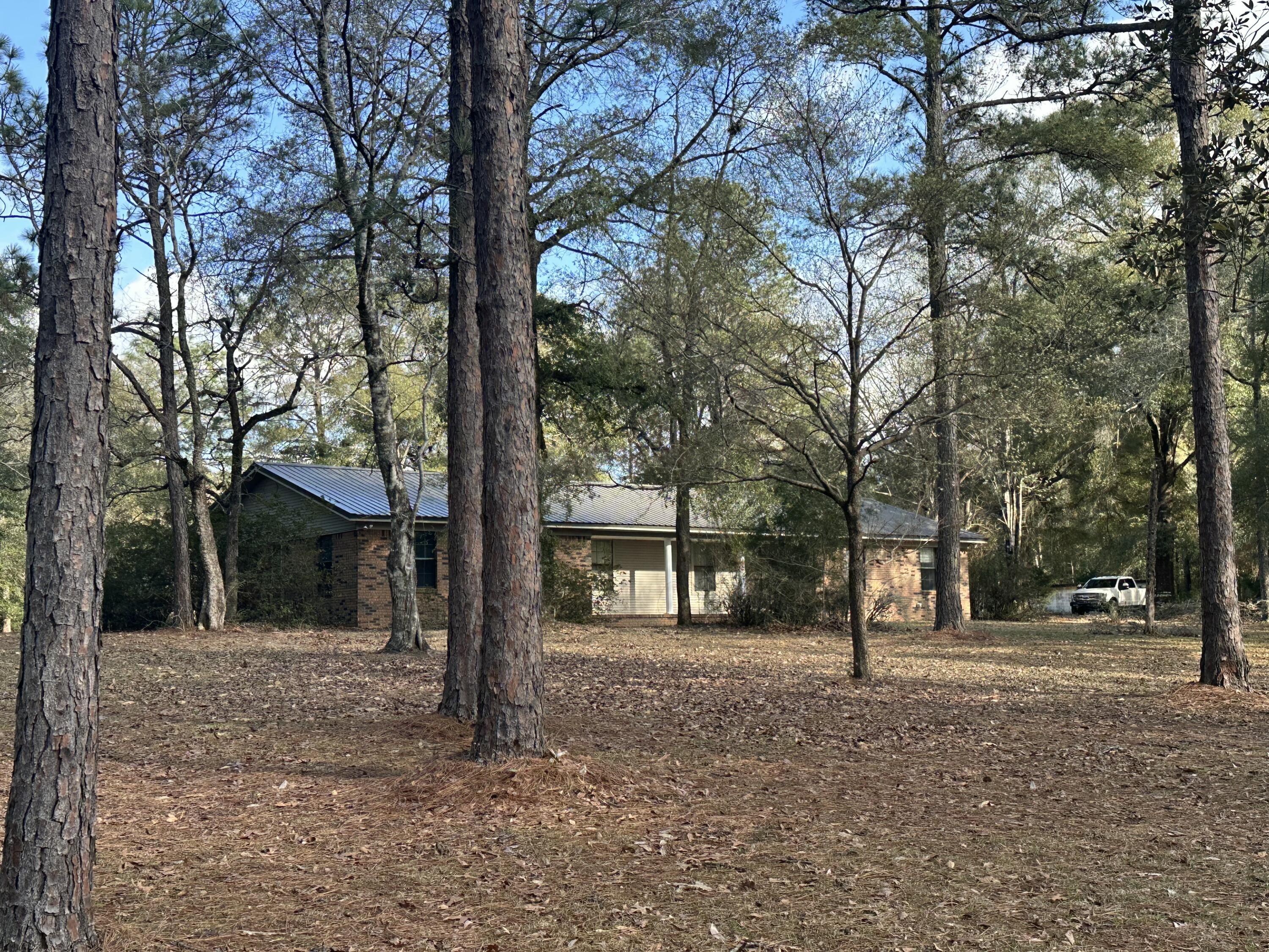 a view of a house with a tree in front