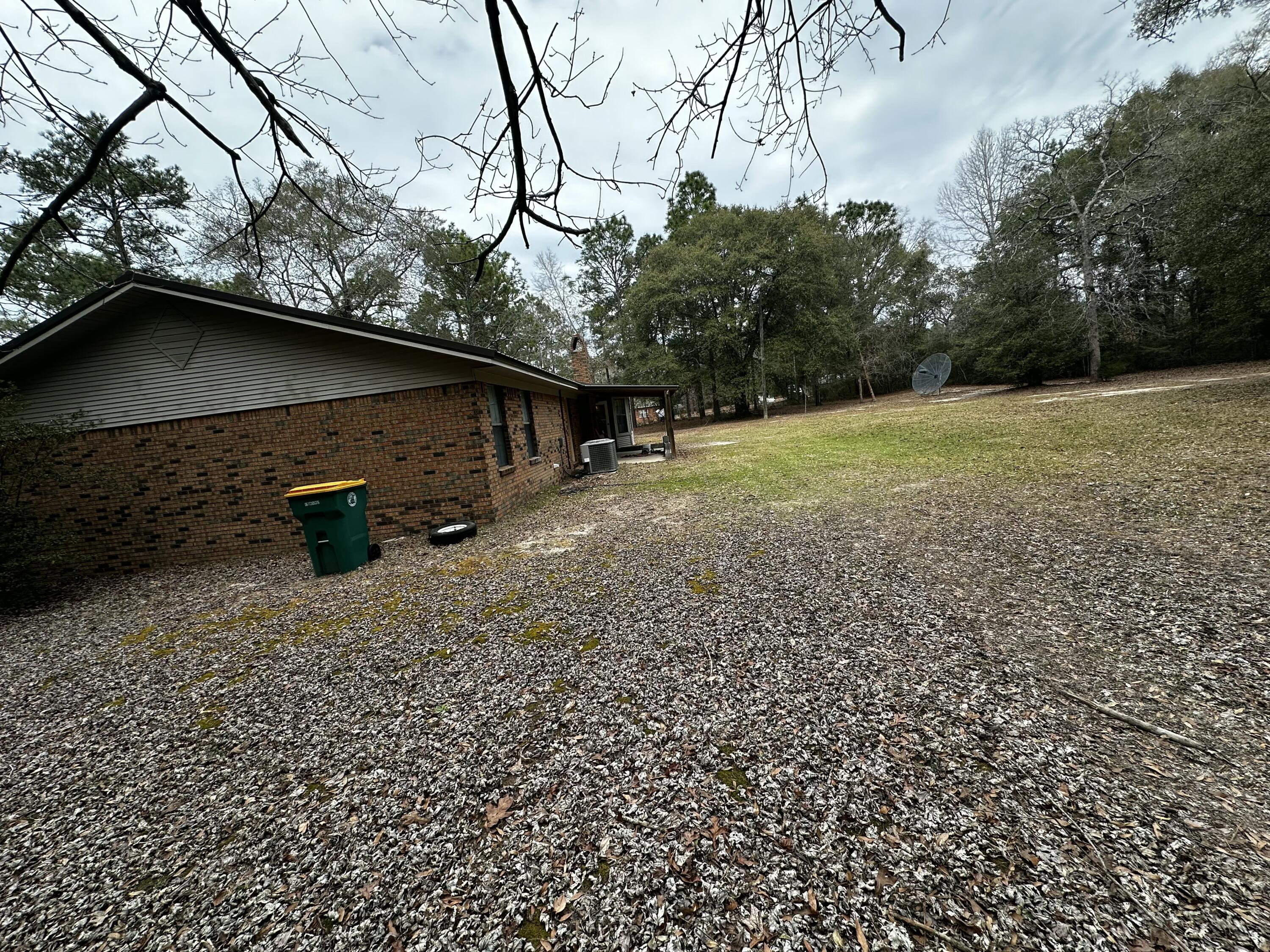 5895 Pineforest Drive Crestview, FL 32539 - Photo 16 of 23 a backyard of a house with lots of green space
