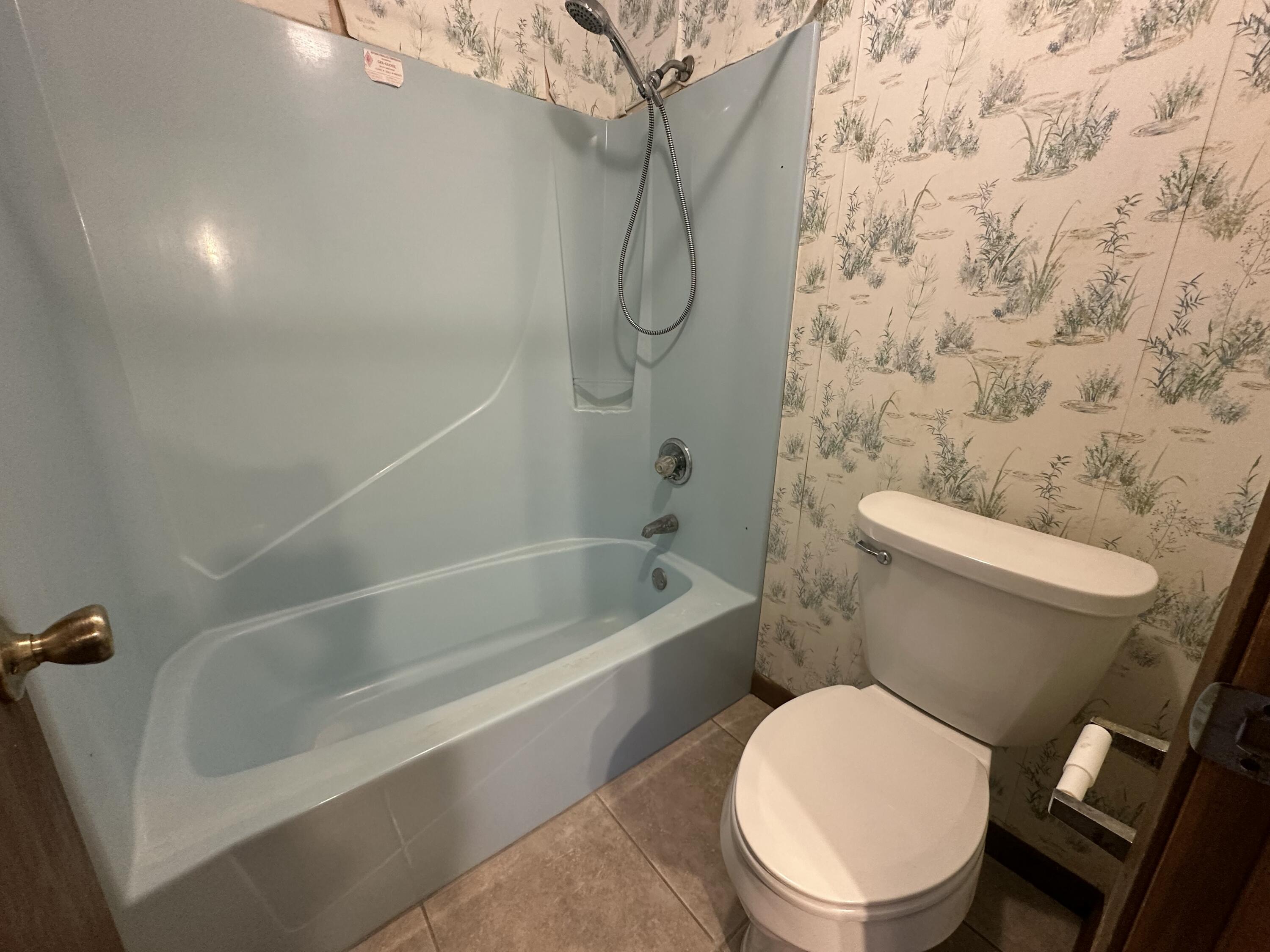 5895 Pineforest Drive Crestview, FL 32539 - Photo 23 of 23 a white toilet sitting next to a bath tub and a shower