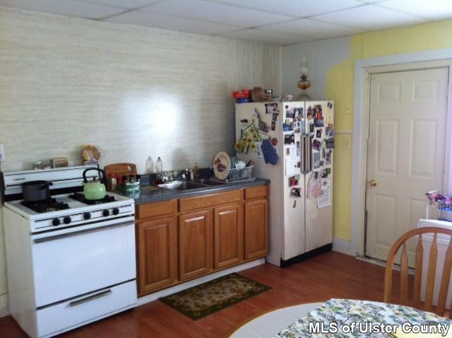 22 Post Street Saugerties, NY 12477 - Photo 4 of 14 a kitchen with stainless steel appliances granite countertop a sink stove and refrigerator