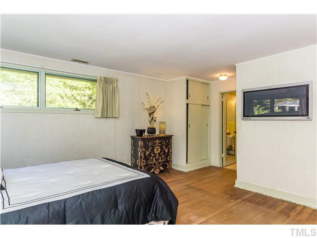 829 Bryan Street Raleigh, NC 27605 - Photo 12 of 23 a bedroom with a bed and a table