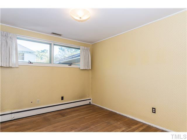 829 Bryan Street Raleigh, NC 27605 - Photo 13 of 23 an empty room with wooden floor and windows